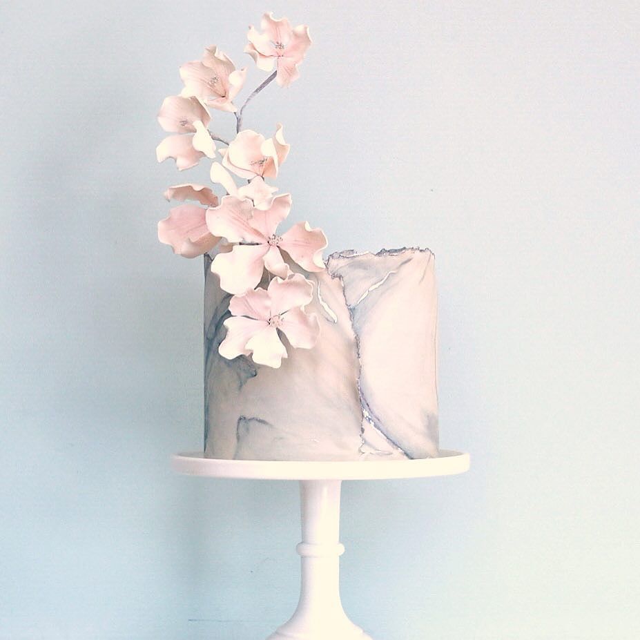 Another #marbled beauty! 💗 Wrapped in torn silver edged fondant topped with a sprig of soft pink flowers. Part of … ift.tt/2fEyRnC