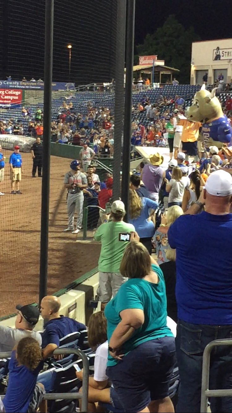 Tim Tebow eyes Tim Tebull after the crowd sings Happy Birthday to Tebow 