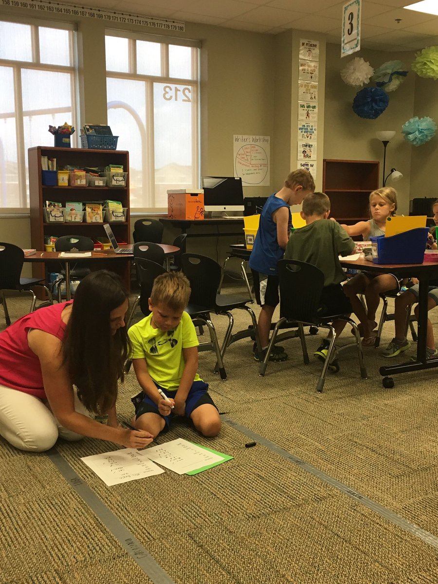 Teachers getting comfy with students to start mastering reading skills in first grade! #pre1718