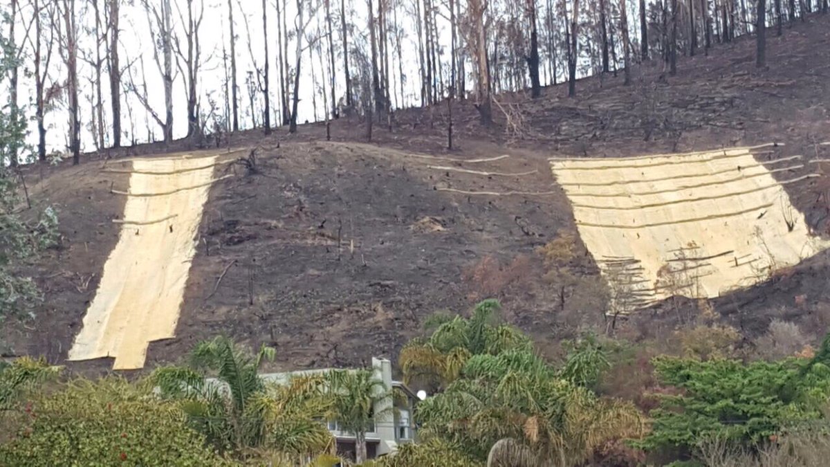 GRRebuild's tweet photo. Bio-sheets and sausages pinned down near the Brenton turn-off Knysna.#GardenRouteRebuild teams worked to prevent mudslides @wo_fire https://t.co/pIUdRpZzei