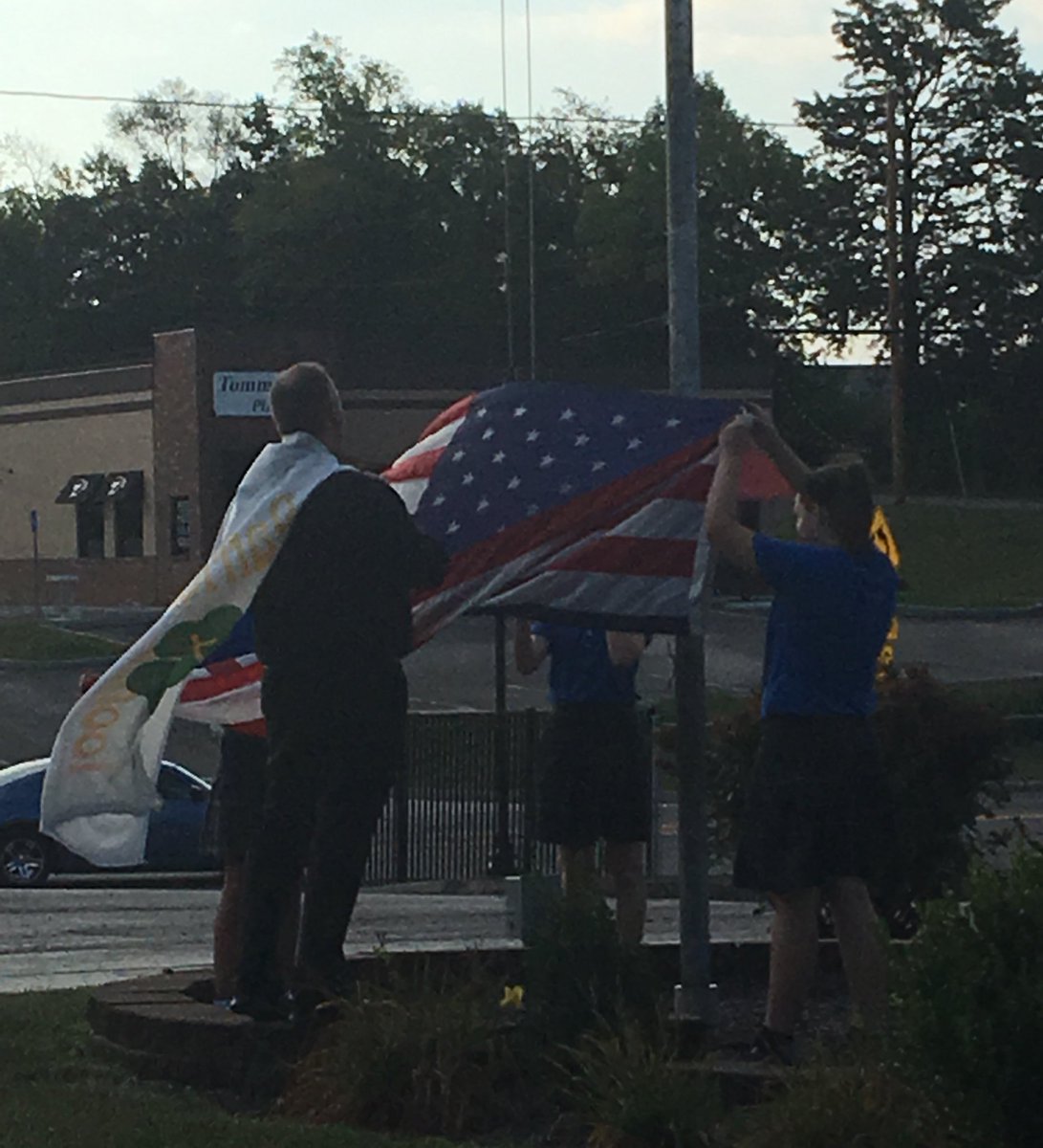 StPatSch's tweet photo. When the pastor "helps" the 8th graders put up the flag in the morning... #FlagCape #IrishFlagAtLeast @PadreBrian #service #StPatProud https://t.co/yeuibFNuO1