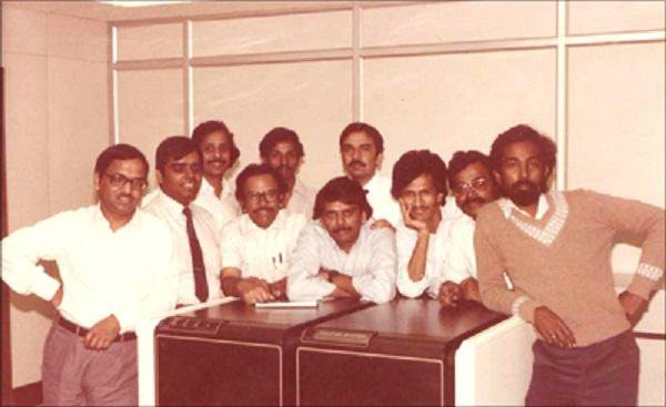 N.R. Narayana Murthy with Infosys founding team in early office setting, showcasing 1980s IT industry beginnings.