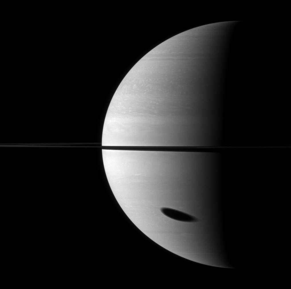 carolynporco's tweet photo. Getting ready for the eclipse? Here Titan's shadow falls on Saturn, creating an eclipse for anyone residing there https://t.co/6ml368GIGZ https://t.co/xT2NW6radJ