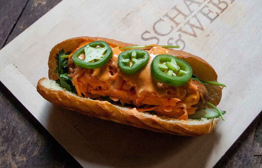 Our Saigon Special: Bauernwurst topped with daikon-carrot slaw, cucumber, fresh jalapenos, cilantro, and some spicy Sriracha aioli.