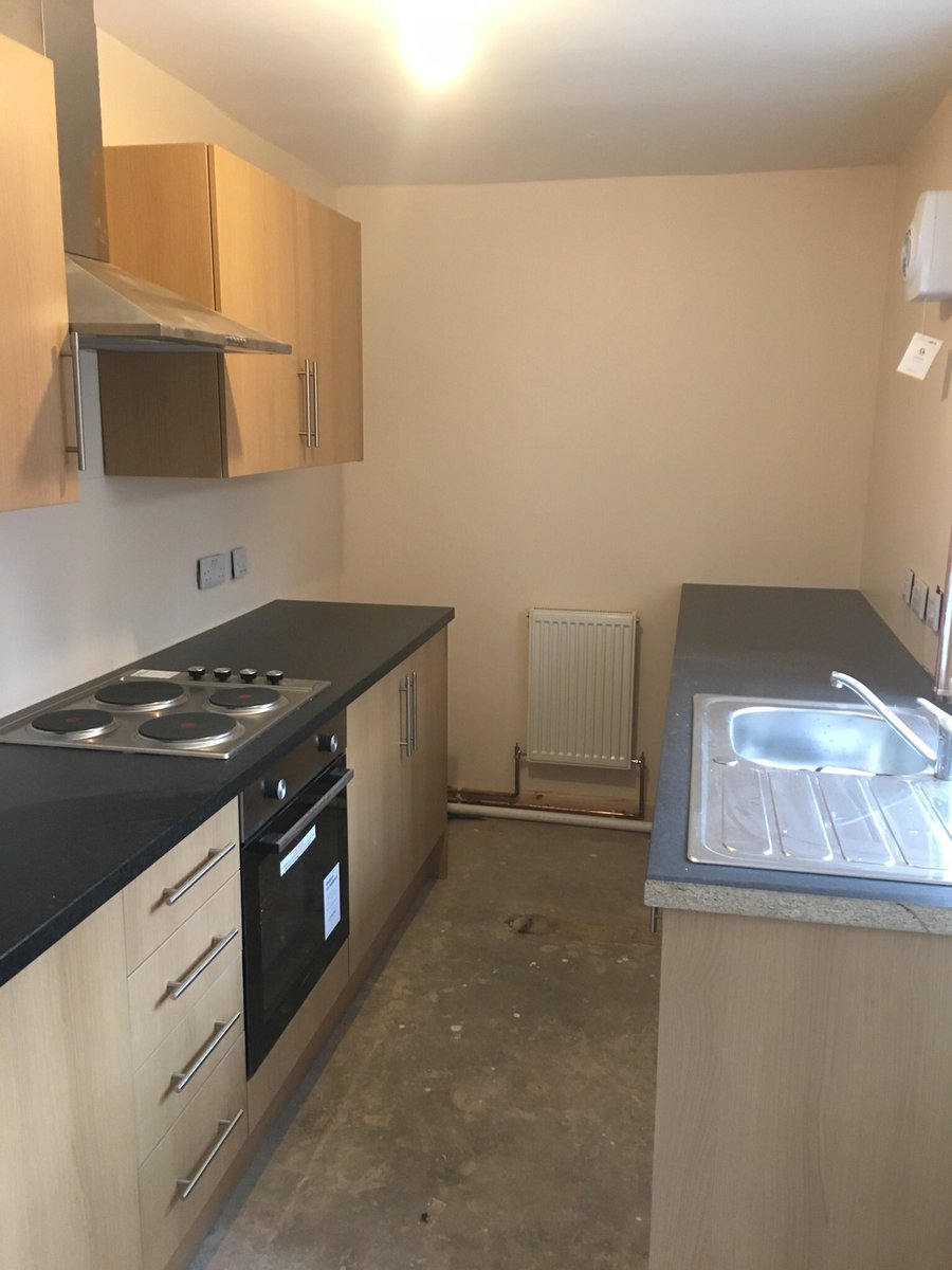 Wall removed to make kitchen bigger boarded plastered new kitchen units ready for tiling