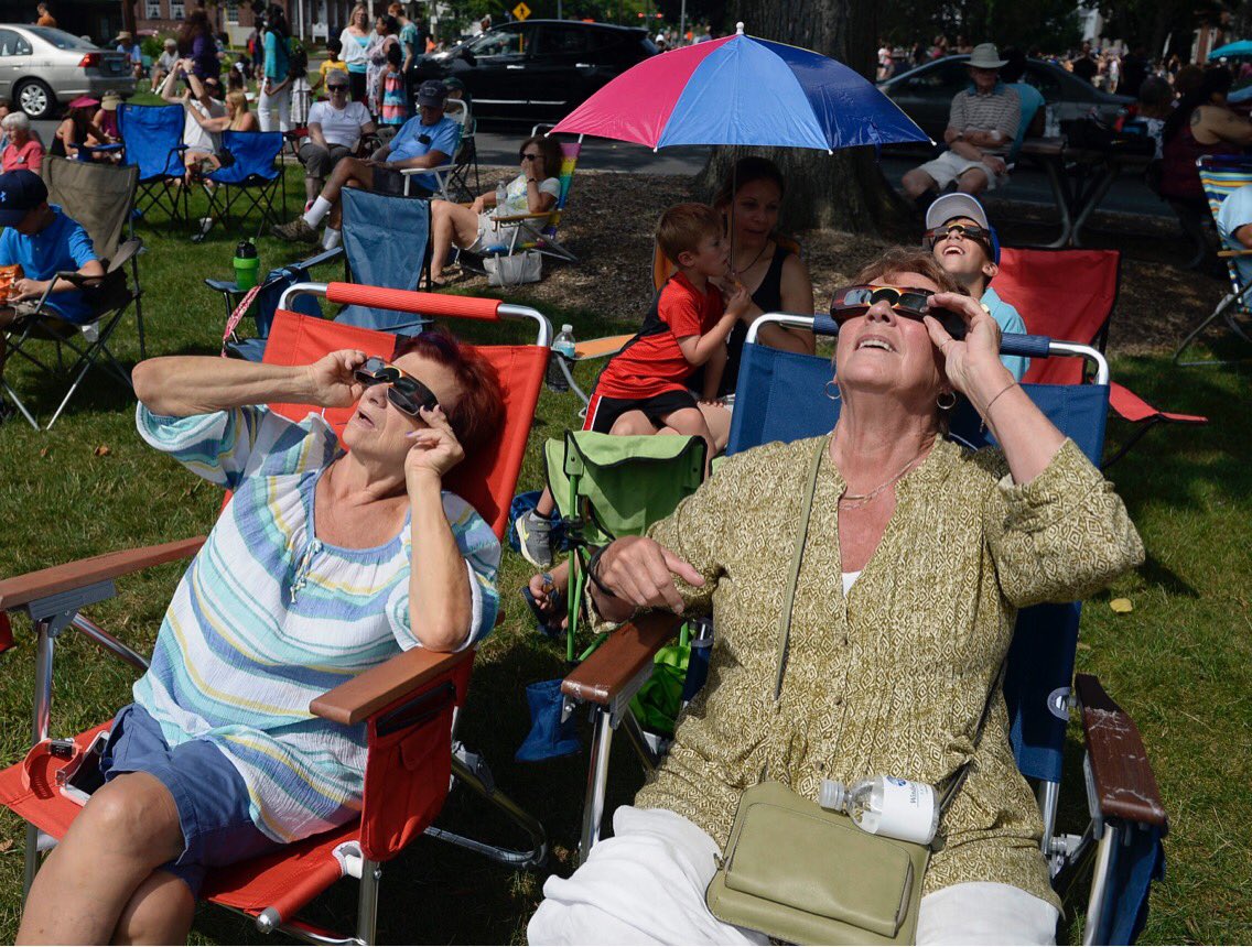 JournalInquirer's tweet photo. Patty LeBrun of Windsor and friend Mary Cameron of South Windsor watch the eclipse from the Windsor Town Green #Eclipse2017CT https://t.co/7p7FVaYb3B
