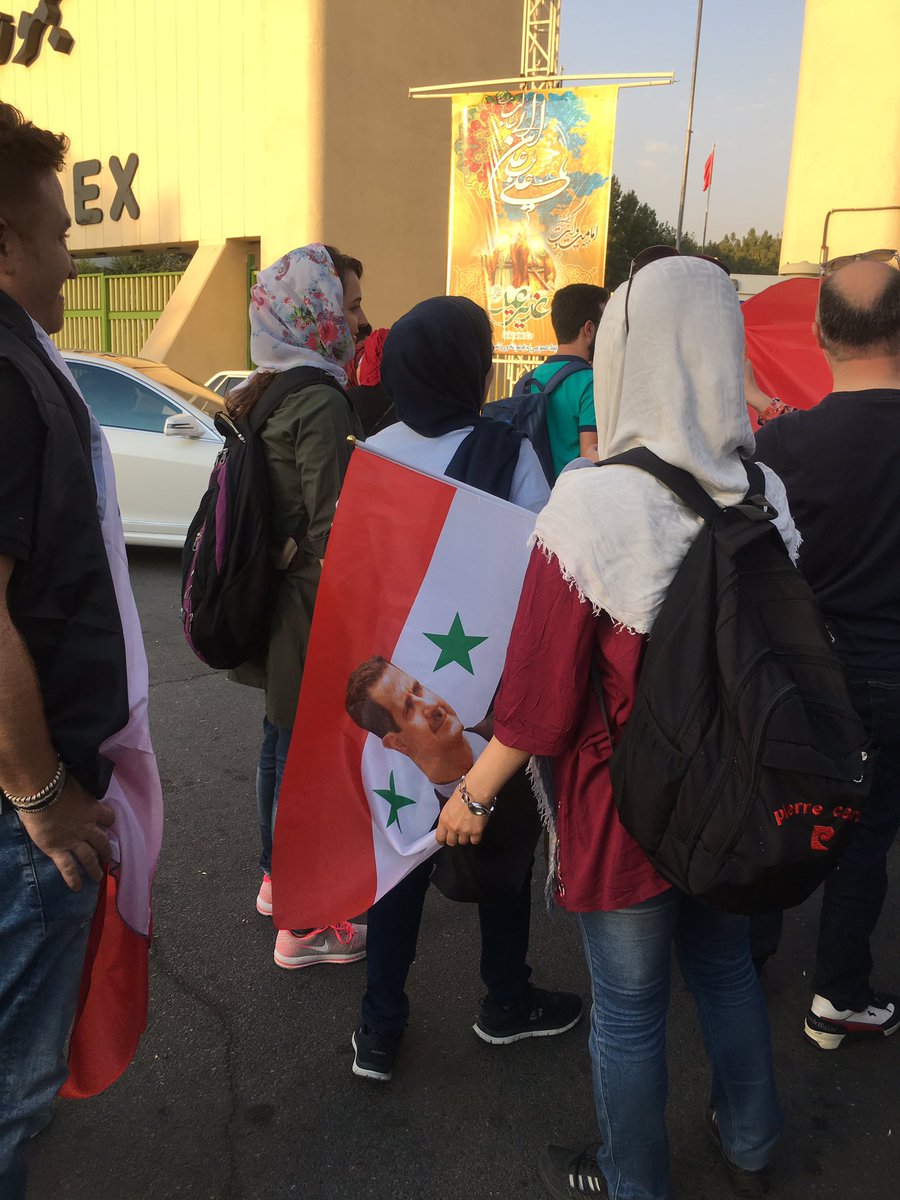 Iranian women are not allowed in the stadiums,but in today's Iran-Syr match,they were offered to carry Assad Syrian flag so they can get in.