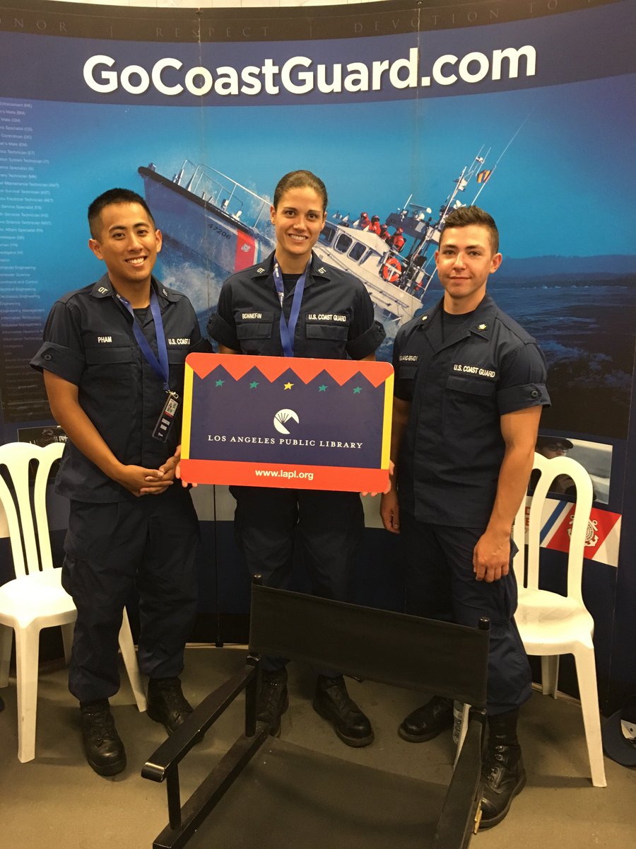3 people holding giant library card