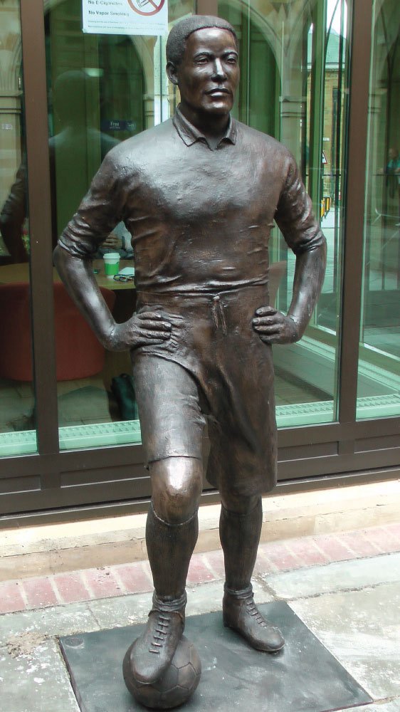 SportingStatues's tweet photo. New Walter Tull statue in Northampton Town Centre and the 1999 memorial @ntfc Sixfields - Tull also played for @ClaptonUltras @SpursOfficial https://t.co/cvelKwazAQ