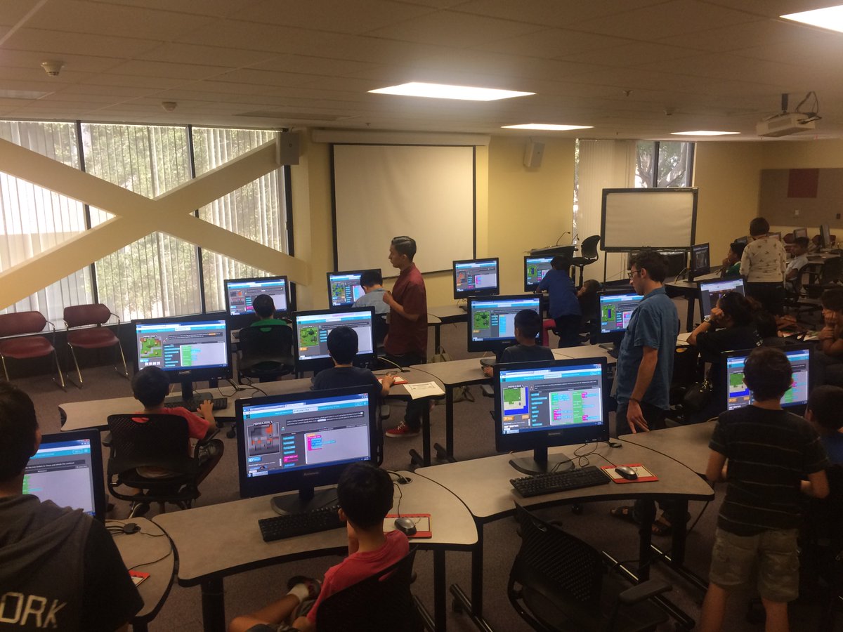 Kids eagerly learning about the basics of computer coding with <a href="/hourofcode/">Hour of Code</a>