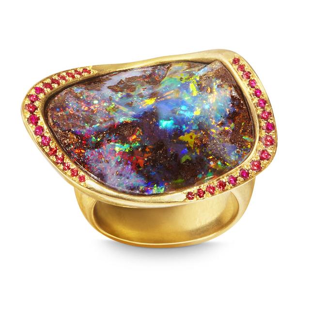 A fiery boulder opal is captured in a setting of 20-karat yellow gold with ruby, and orange and red sapphires. ow.ly/ih9D30b4sOD