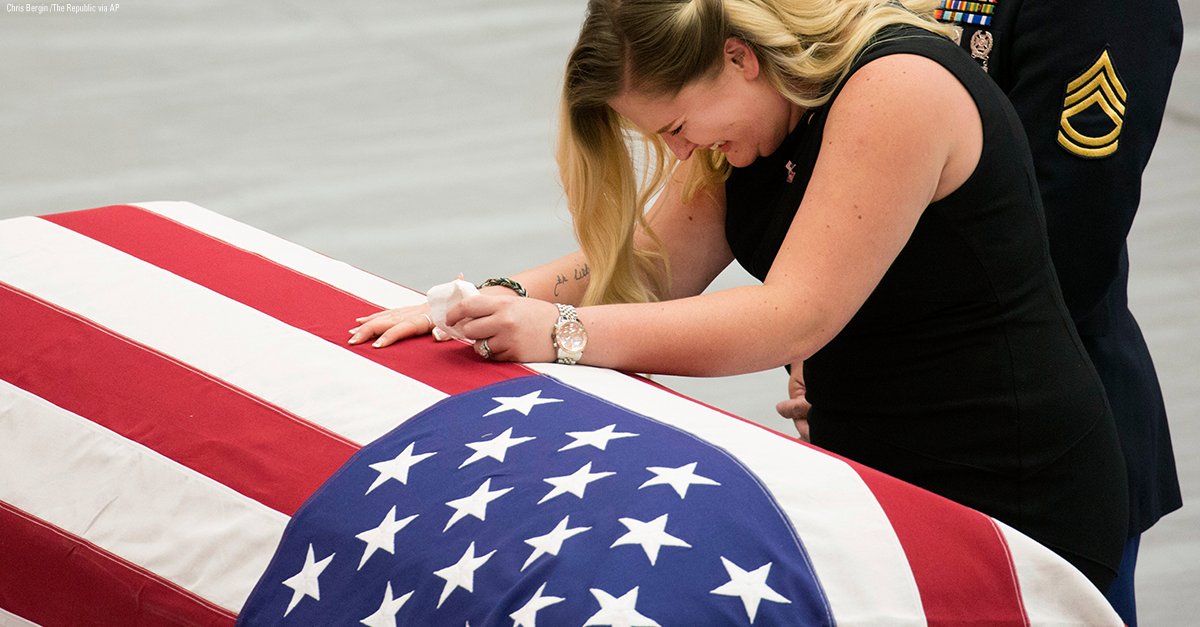 A woman mourns the loss of her husband during the funeral services for Army Sgt. Jonathon Hunter in Columbus, Indiana.