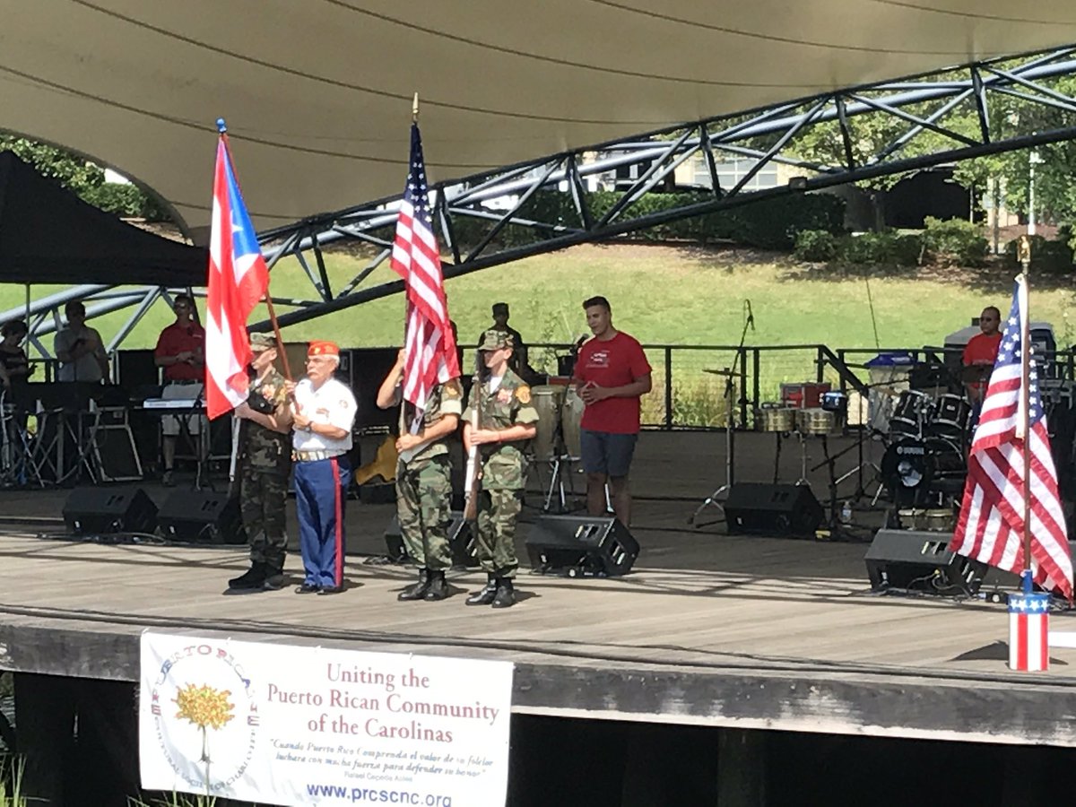 NCespanol's tweet photo. 🇺🇸🇵🇷 Flag Presentations at #PuertoRicanFestival2017 in Symphony Park @SouthParkMallNC Come out for the @AARP Domino Tournament https://t.co/PsqrIje2EN