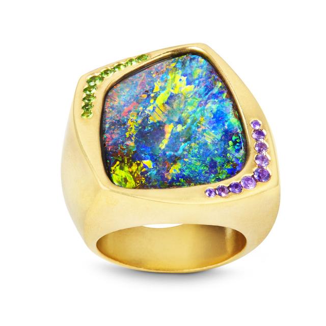 An elegant  boulder opal's deep luminosity is complemented by a spray of violet sapphires and green garnets ow.ly/XWsb30aKxAd
