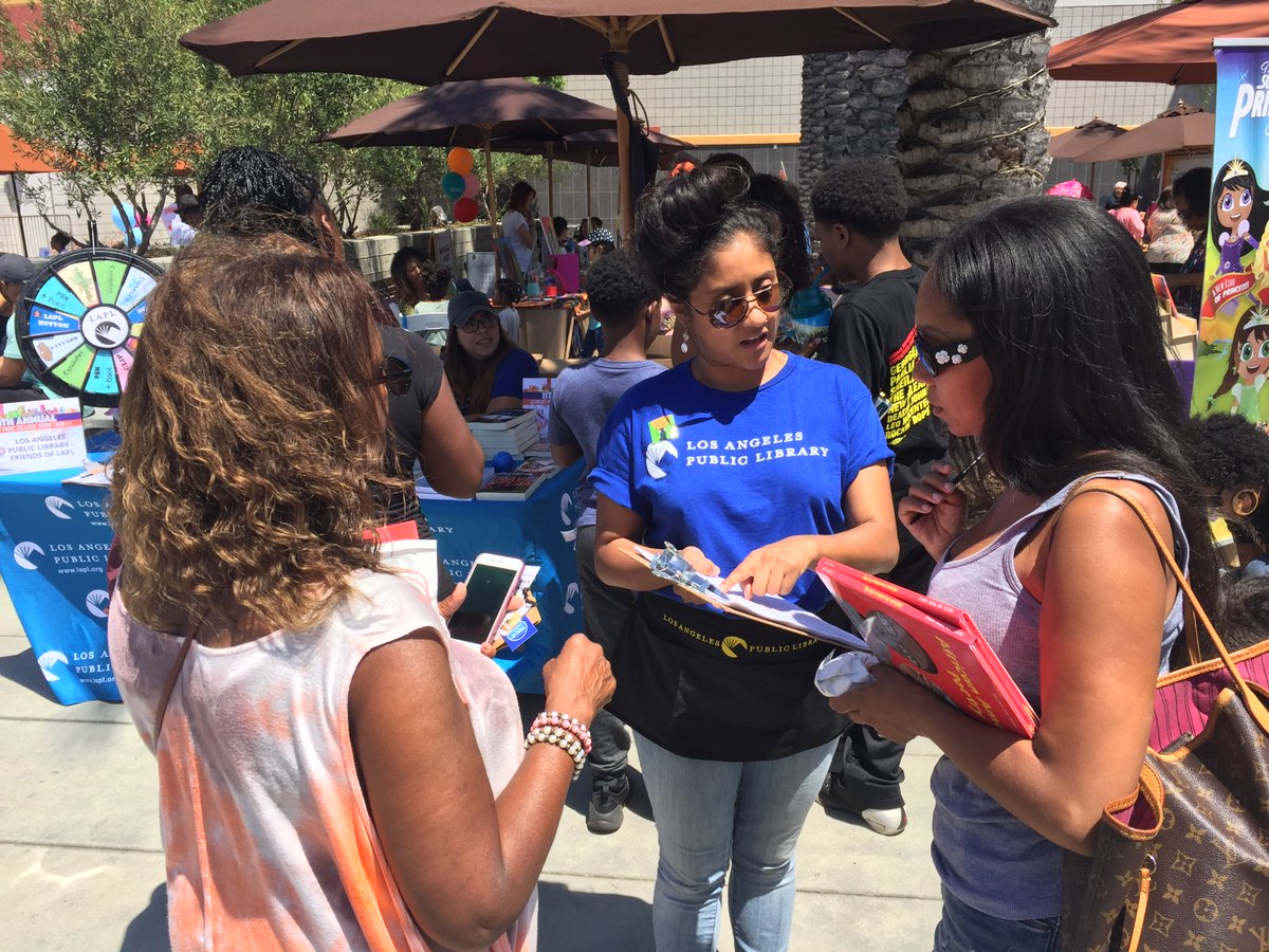 LAPL employee signing up people for a library card