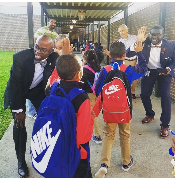 UNCGHRL's tweet photo. Today @uncgdos Dr. Brett Carter & HRL Assistant Director @DM_UrFuturePrez (right) greeted North Hills students back to school! #LeadAtG https://t.co/1byAKm7nPA