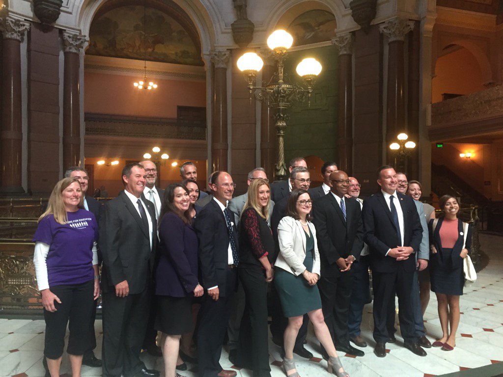 AmandaVinicky's tweet image. Sen. Manar, Rep. Davis, various superintendents and #fixtheformula coalition members celebrate with hugs after vote