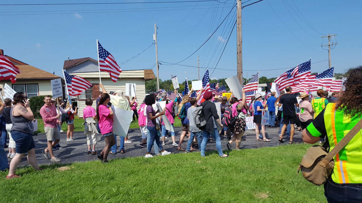 Protesters file from Springfield Teamsters Hall to take positions along Glenstone Avenue in advance of the visit by President Donald Trump