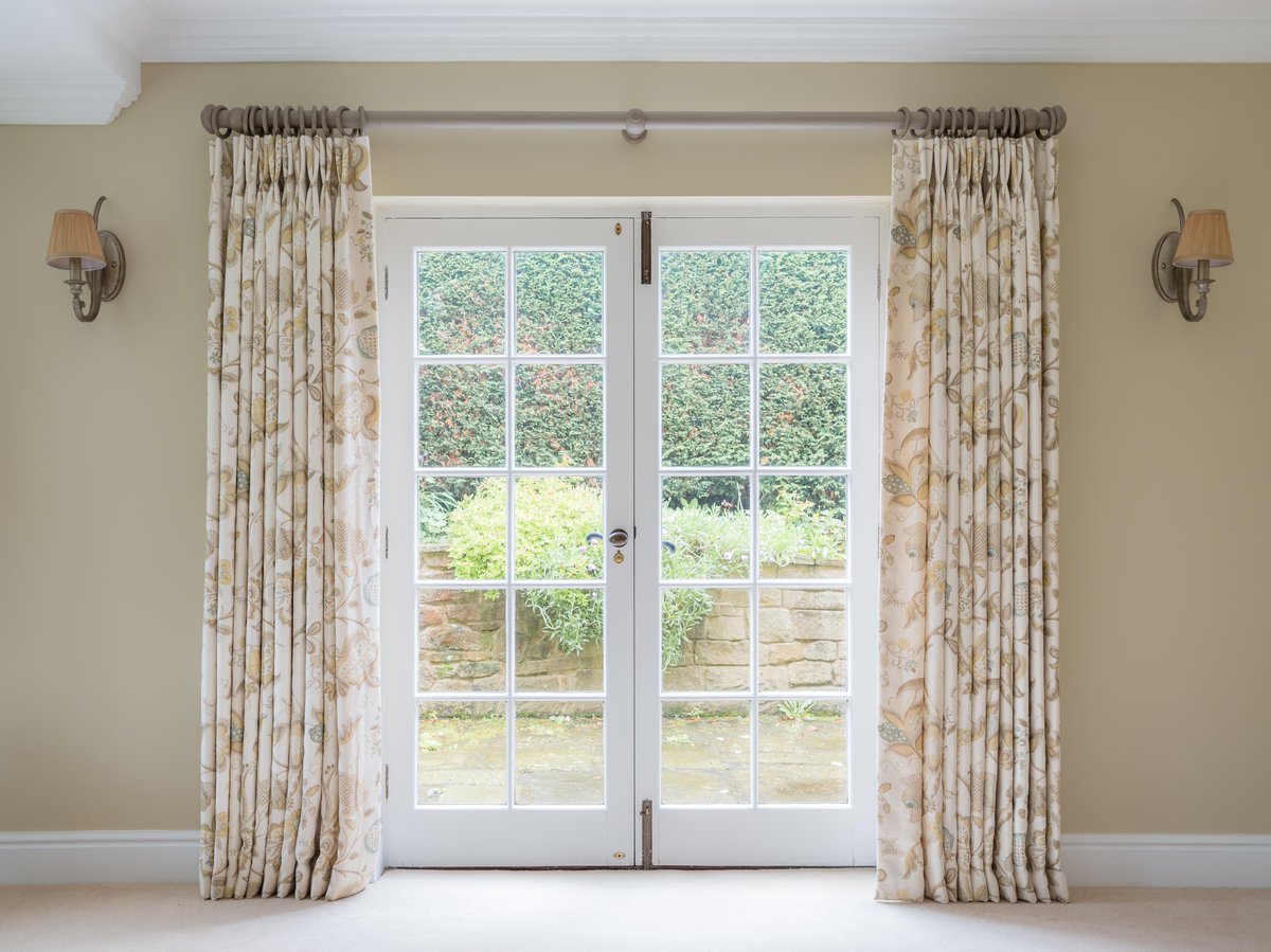 Linen curtains with a subtle blue and gold print perfectly compliment the walls and fixtures in this living room! 
Fabric <a href="/SandersonFW/">Sanderson</a>