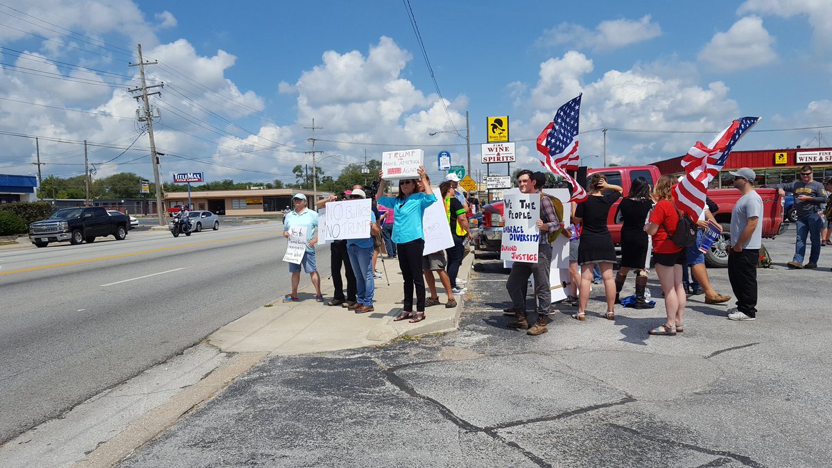 Protesters lined both sides of Glenstone Avenue on Wednesday to protest the visit by President Donald Trump.