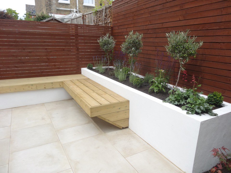 Groundteam's tweet image. Back Garden Back garden in Wimbledon with sandstone patio, painted horizontal fence, ... groundteam.co.uk/landscaping-pr…