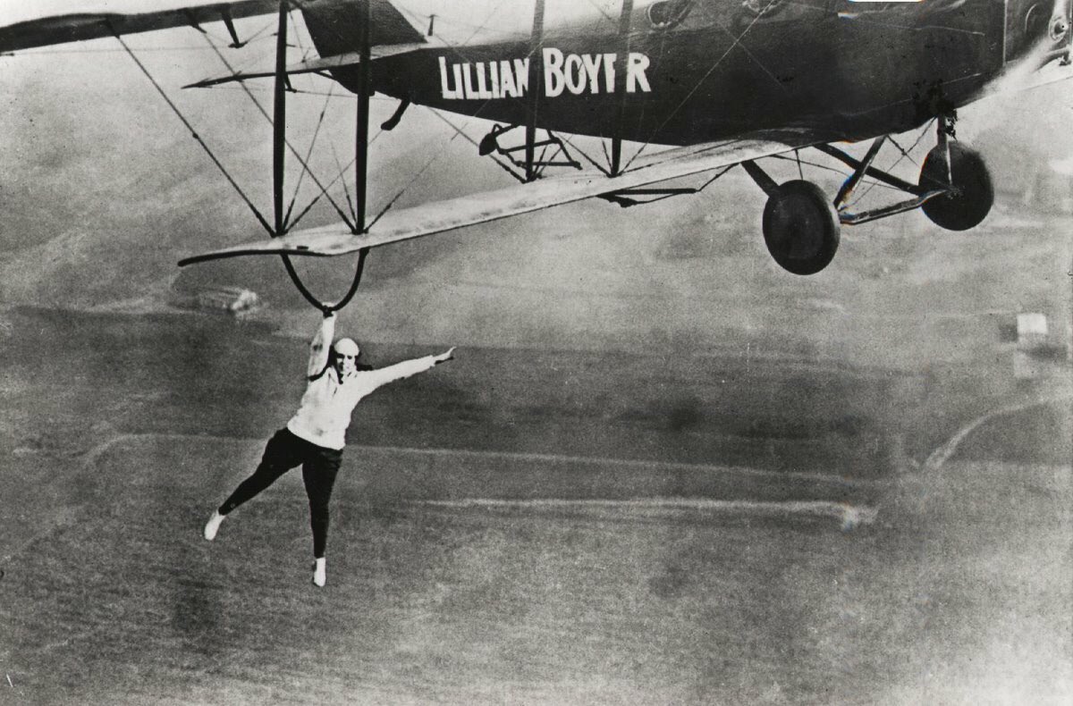 Silodrome's tweet photo. Legendary wing walker Lillian Boyer dangles from a biplane (with no parachute) - 1922.

#wingwalker #women #brave #hero #plane #biplane https://t.co/DCKWx6rWEk
