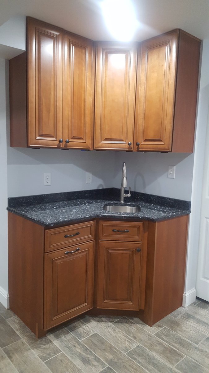 accurateupgrade's tweet photo. A beautiful wet bar with blue pearl granite counter tops with under cabinet lighting. Call or message us today so we can upgrade your home! https://t.co/6MvWxwn45G