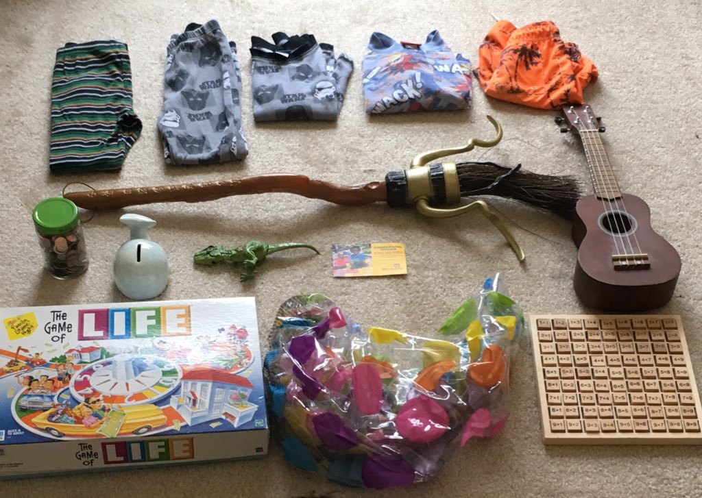 MagStewart's tweet photo. What my 8 y/o son would pack if we evacuate! Ukele, PJs, quidditch broom, Game of Life, dinosaur, piggy bank, pool toy, bathing suit! https://t.co/aypl1OA2CW