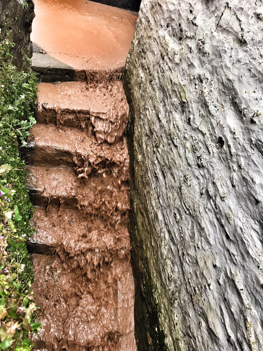 maxinepolperro's tweet photo. Streets are paved in chocolate milk as the rain continues, hope that drain holds out, as I have no sandbags #Cornwall #Polperro https://t.co/jtYeyvZraR