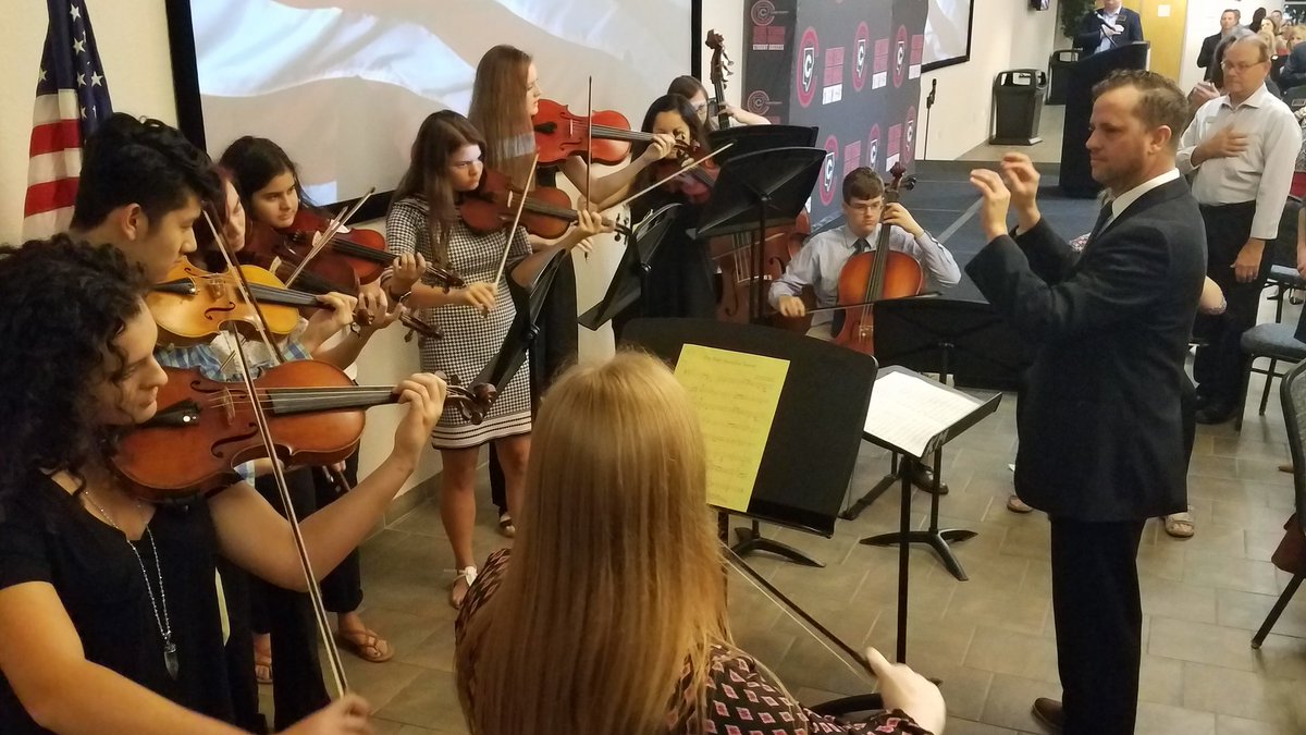 Members of Kennesaw Mtn HS Chamber Orchestra perform national anthem at Cobb Leadership &amp; Learning Meeting at the KSU Continuing Ed Center.