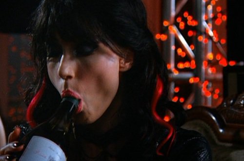 Birthday girl Shannon Elizabeth making a wine bottle far more happy than it deserves. 