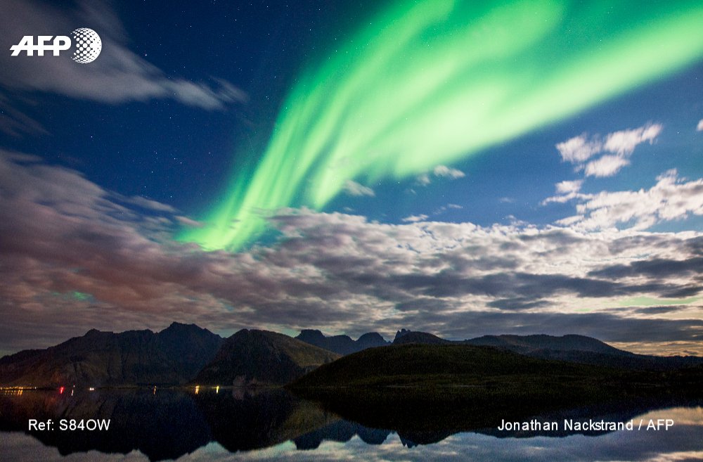 Northern lights (aurora borealis) illuminate the sky over Torsfjorden near Reine, on Lofoten Islands, Arctic Circle. 📷 <a href="/jnackstrand/">Jonathan Nackstrand</a>