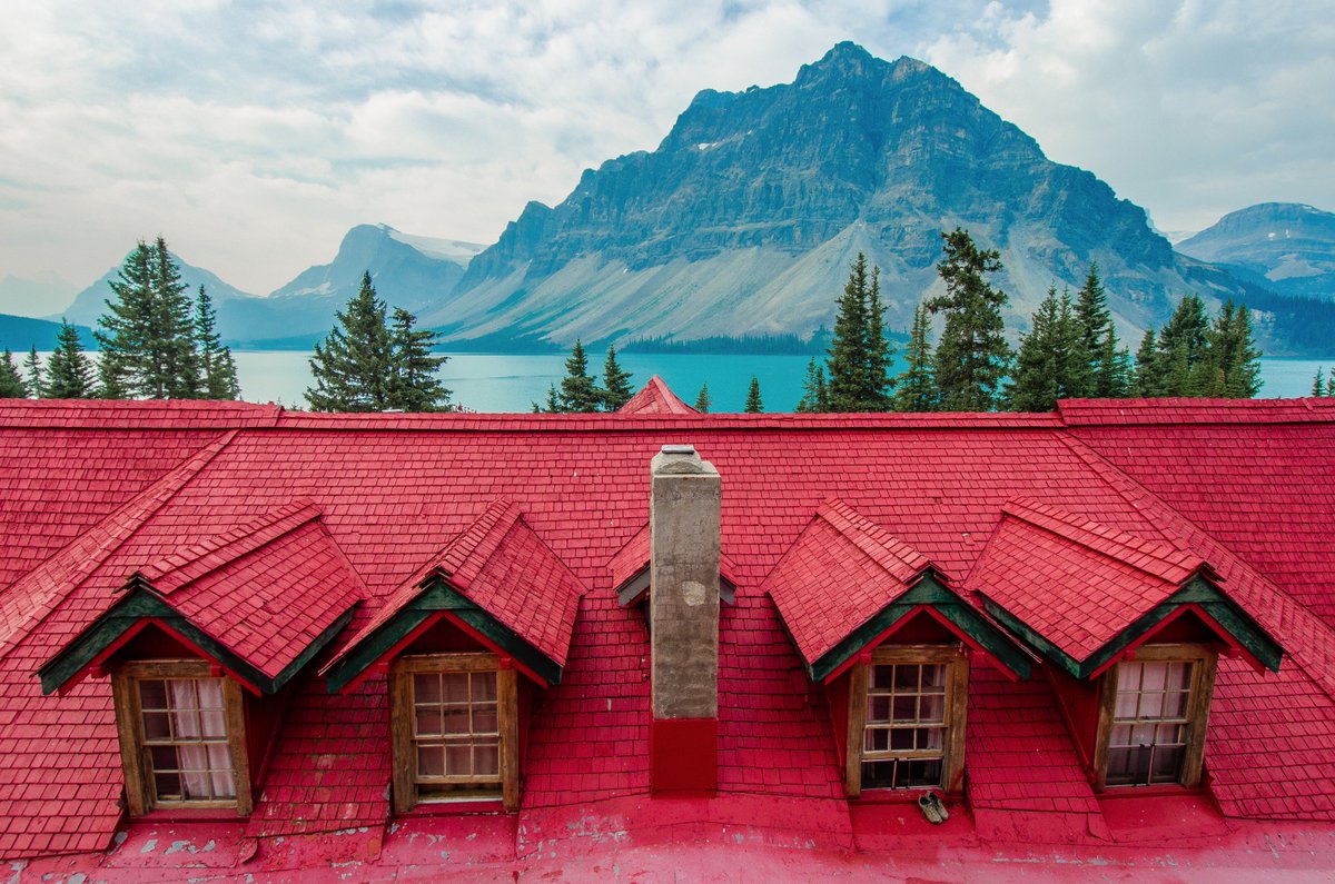 Muddied boots are left out to dry in the imposing shadows of a towering peak. #Canada #landscape #mountains