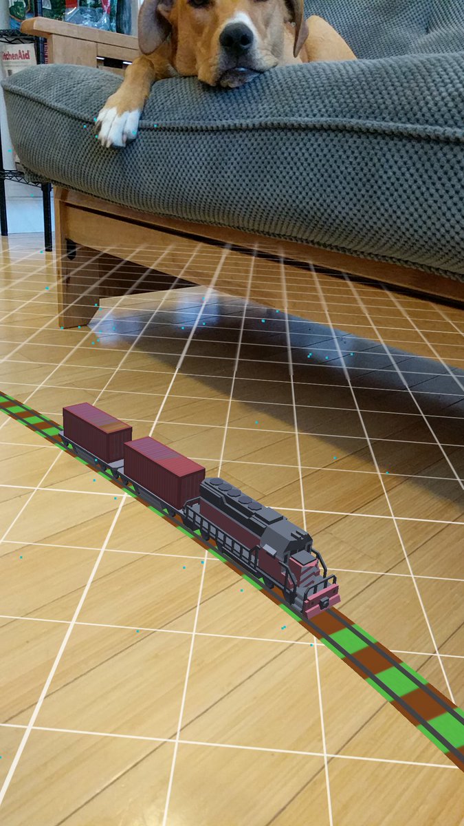 The_Tall_Matt's tweet photo. My puppy seems very unimpressed with my AR model train. #MadeWithUnity #MadeWithARCore https://t.co/nH2wa0mvzP