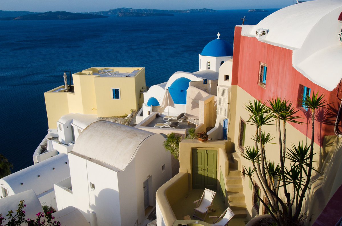 A motley assortment of Cycladic architecture adorns the pumice packed sea edge. #Greece #landscape