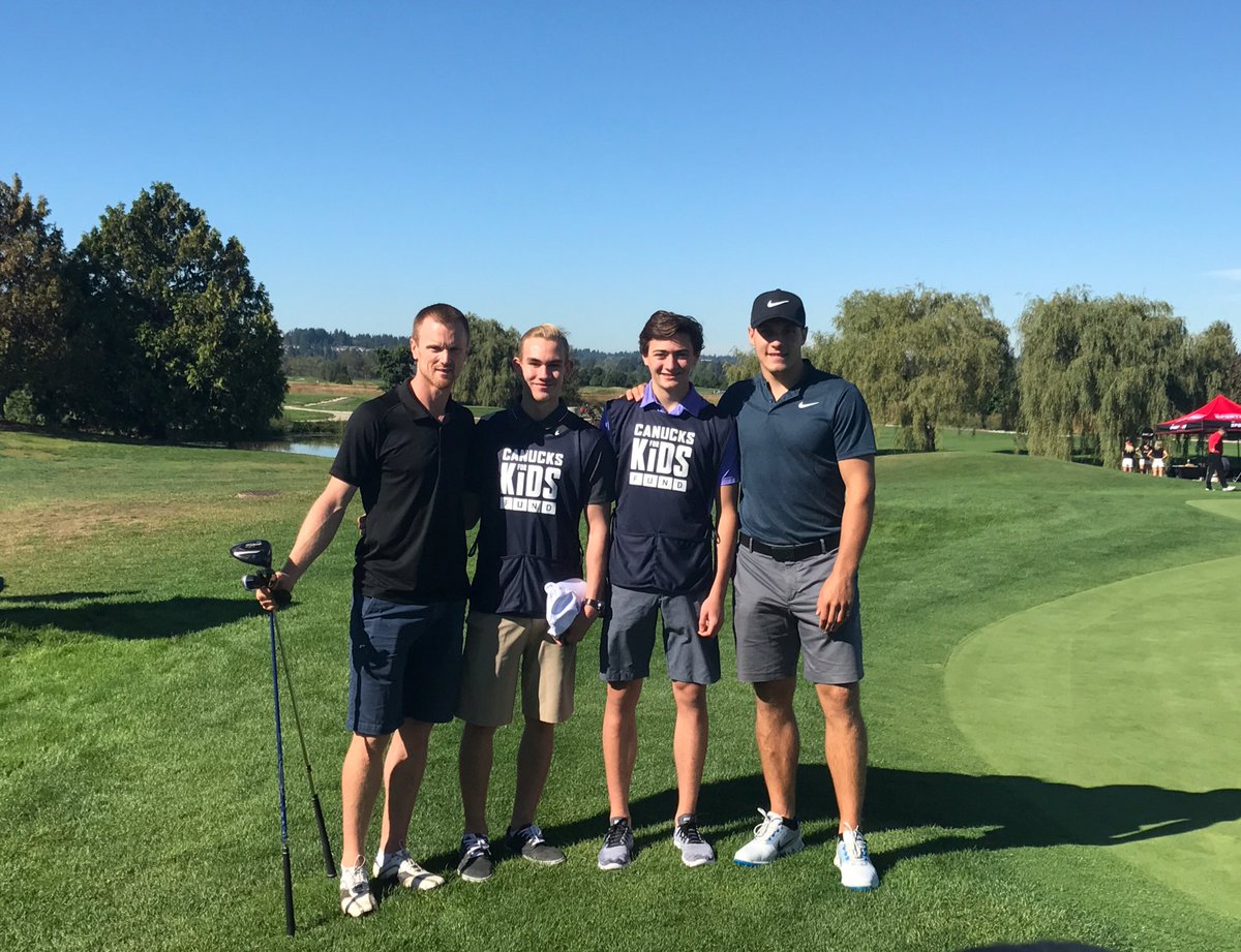 Canucks's tweet photo. Henrik and Horvat kick off #TheJake17 with their caddies for the day. Guesses on who needs more advice...? https://t.co/E61ITtuiKA