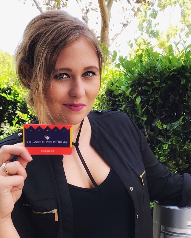 Woman holding a library card