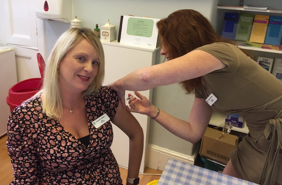 Helen giving fellow pharmacist Evie her flu jab. All pregnant women are entitled to a free NHS flu jab,available at the pharmacy from Monday