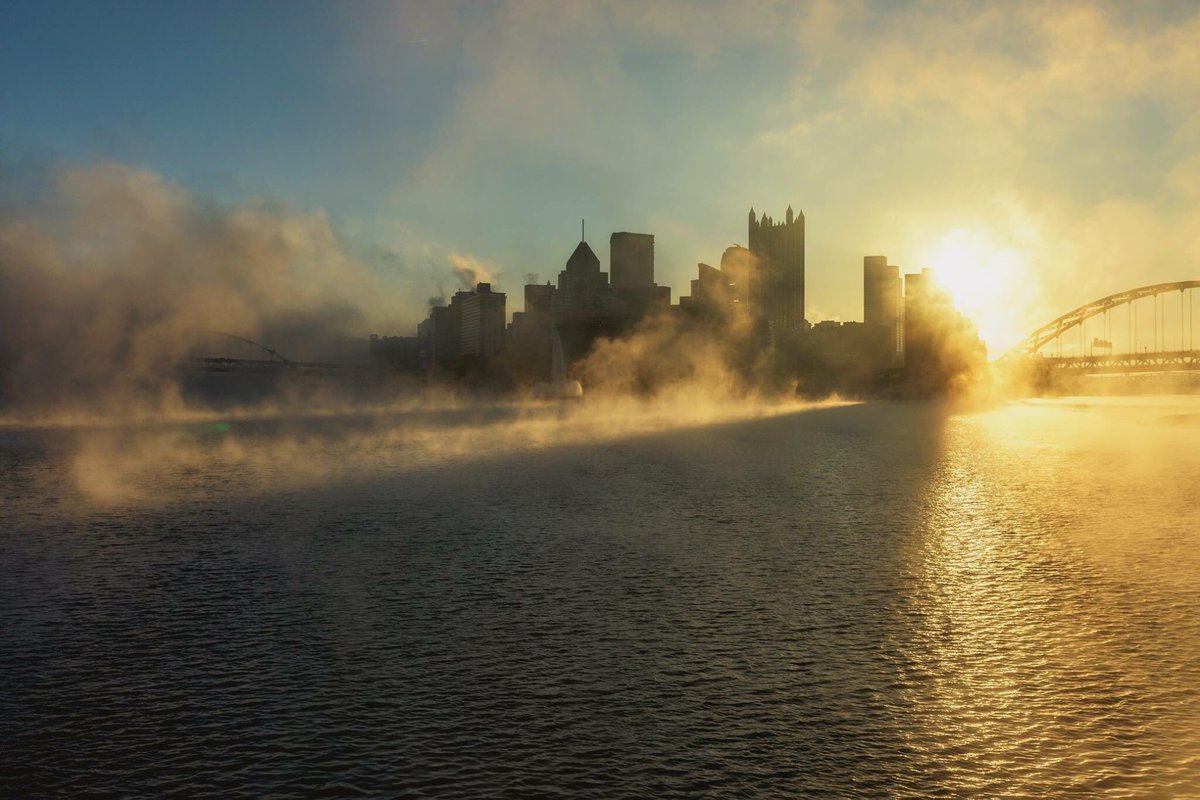 The rising sun cuts through the fog as it casts long shadows on the rippling Ohio River on a moody #Pittsburgh morning.