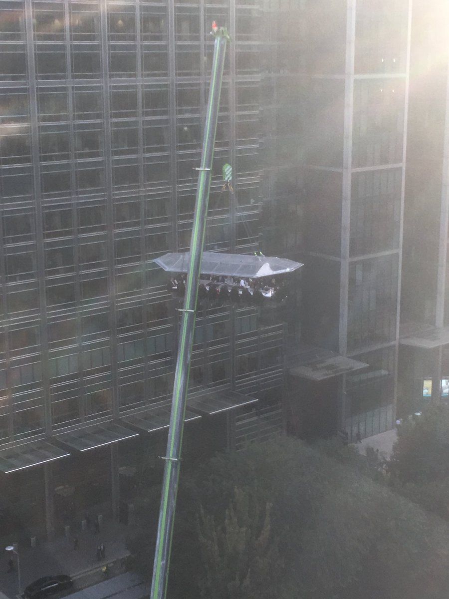 Yes, of course there are a bunch of folks having an open air dinner hanging off a crane here in Canary Wharf.