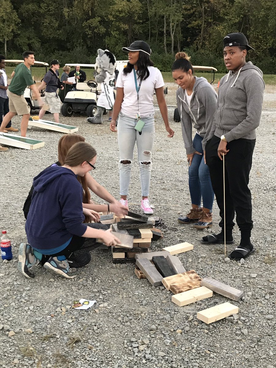 WSUWBasketball's tweet photo. The team out at the bonfire making s'mores and s'more.. friends 😂#WrightState50 https://t.co/2R3kJd15W3