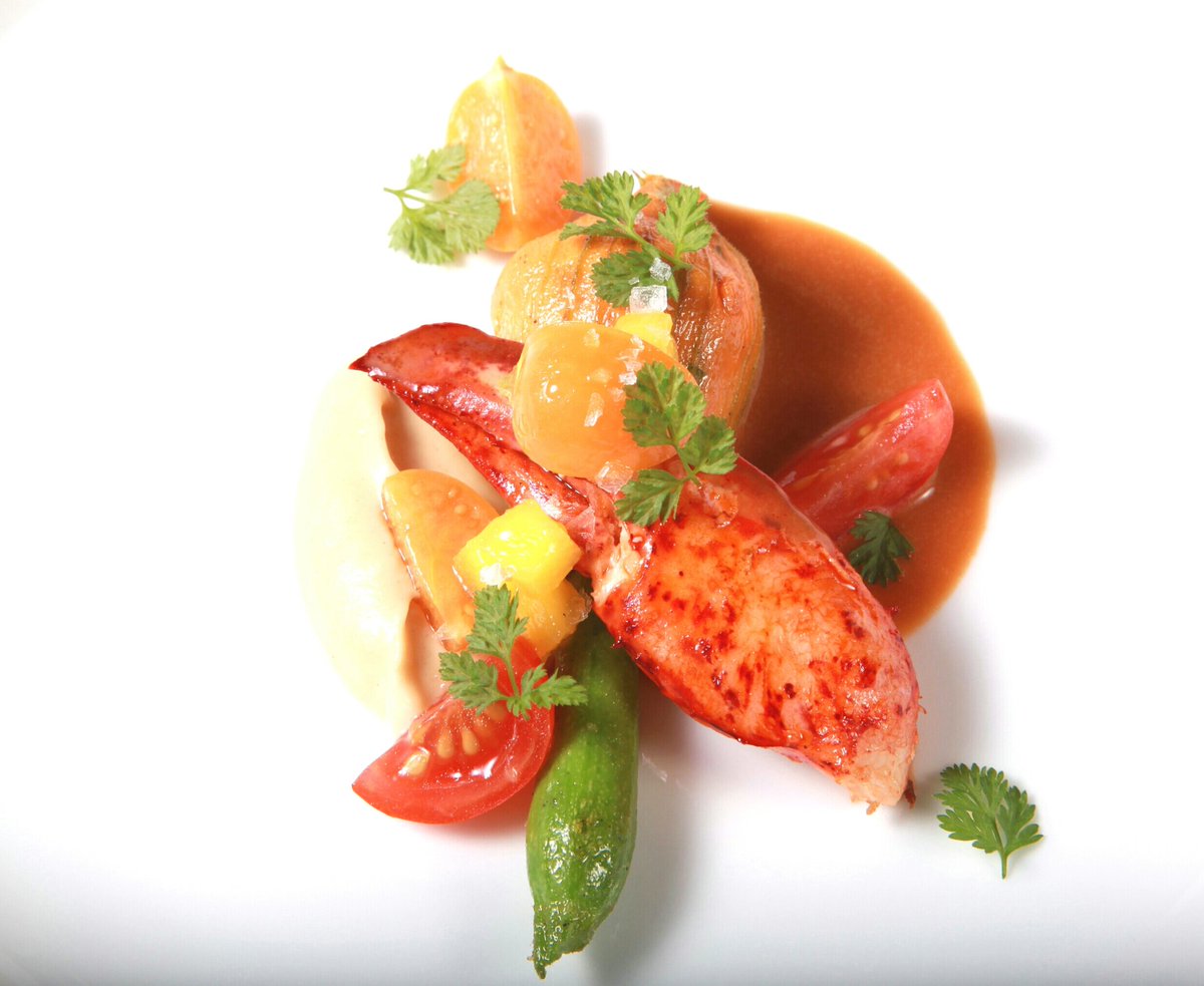 Poached Maine lobster and stuffed zucchini blossom.<a href="/LesNomadesChi/">Les Nomades</a>