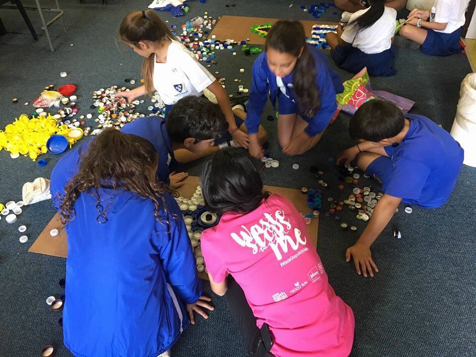 #MissEarth South Africa 2017 Irini Moutzouris teaching school children to create recycled art out of old bottle caps.