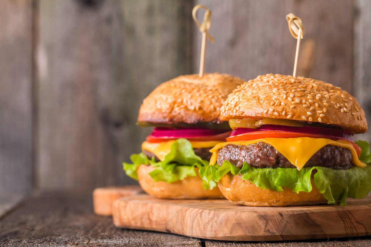 It's #NationalCheeseburgerDay! We suggest a juicy burger at The Launch Bar &amp; Grill.