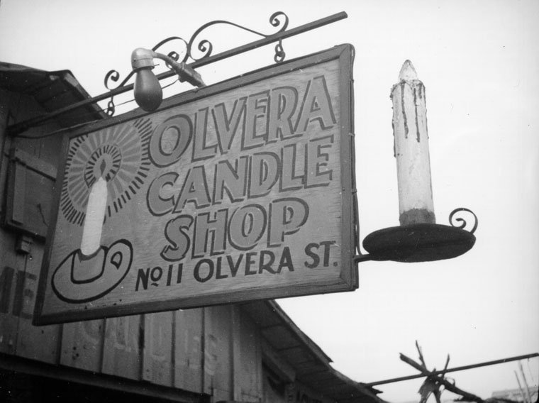 Sign with the name Olvera Candle Shop