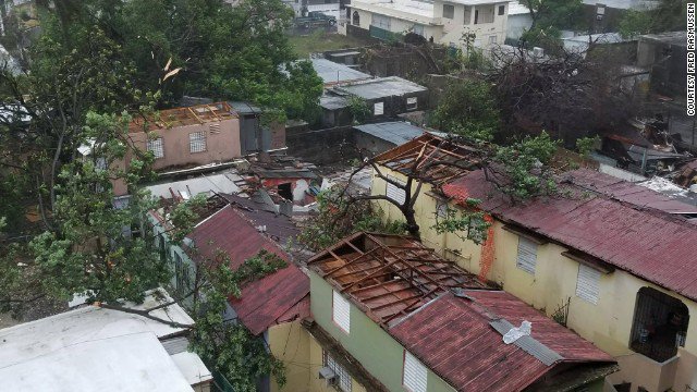 CNN's tweet photo. Hurricane Maria ripped the roofs off these homes in San Juan, Puerto Rico https://t.co/VGpWK7tl7e https://t.co/jnt6nRhRXR