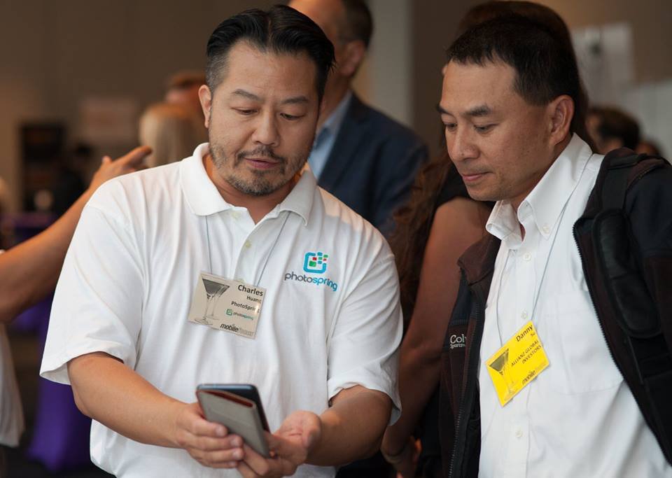 PhotoSpringInc's tweet photo. Showing a #PepCom attendee how easy it is to use our digital frame & album for photos and videos. https://t.co/M46cOSbT70 #MobileFocus https://t.co/tHd668qfkU