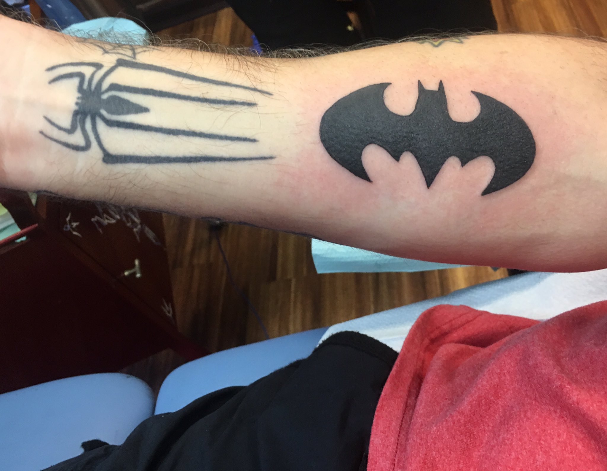 Batman logo tattoo on the left side ribcage.