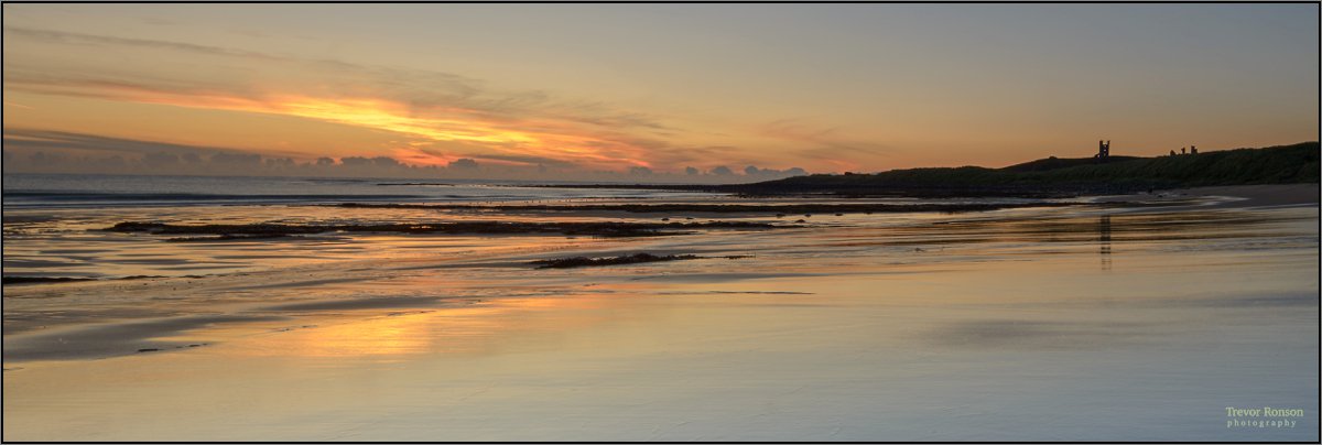 RonsonPhoto's tweet photo. Wet sands of Embleton beach and Dunstanburgh Castle silhouette. #northumberland #landscapephotography #dawnbeach https://t.co/RNzoMlRN0S