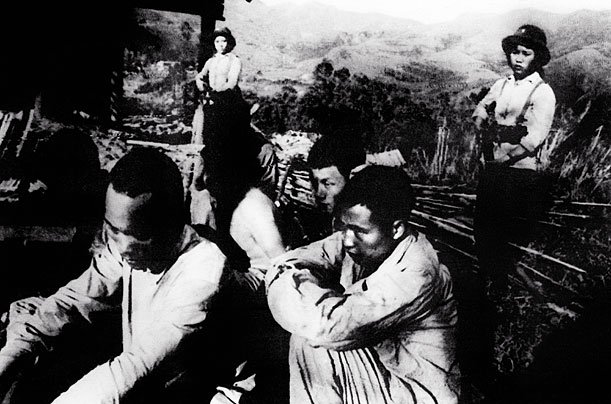 Chinese POWs at a Vietnamese camp, guarded by women soldiers of Vietnam